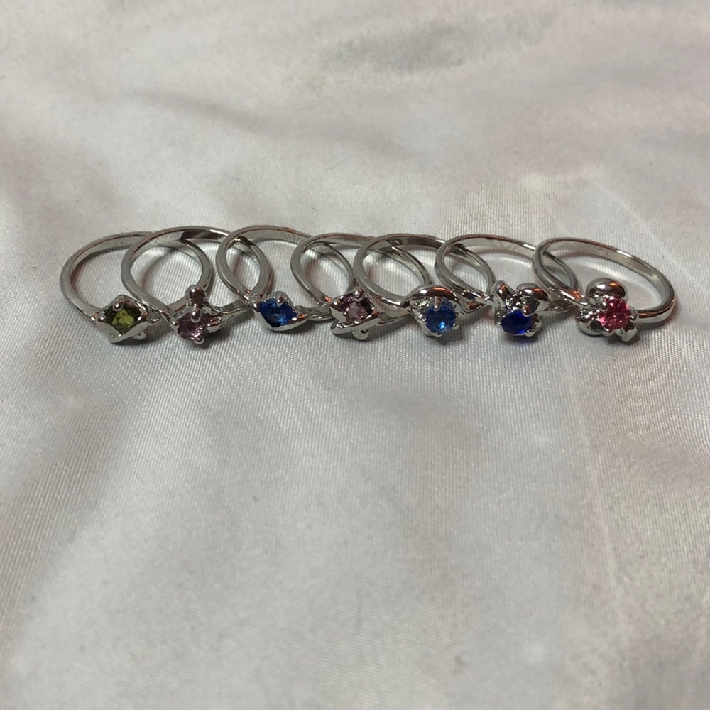 Pack of 7 silver rings with multi colored gems